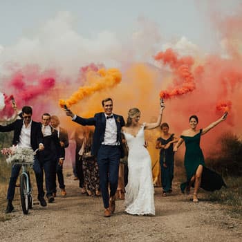 Молодожёны и гости на свадебной фотосессии в Минске с цветными дымовыми шашками